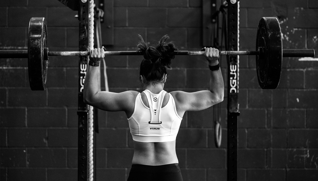 Closeup of weightlifter clapping hands before  barbell workout at the gym