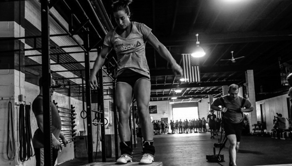 Closeup of weightlifter clapping hands before  barbell workout at the gym