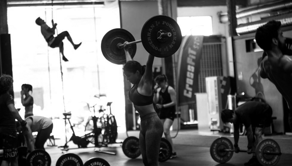 Closeup of weightlifter clapping hands before  barbell workout at the gym
