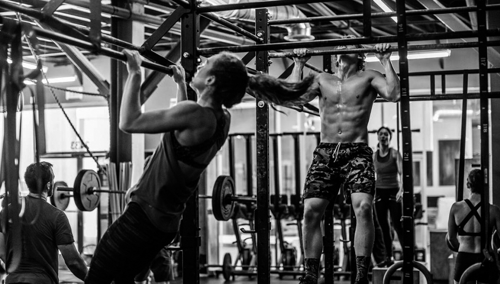 Closeup of weightlifter clapping hands before  barbell workout at the gym